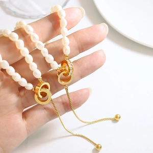 Freshwater pearl necklace with gold double ring pendant and sparkling rhinestones