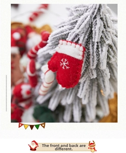 Detail of red wool felt Christmas glove ornament with white snowflake and wave trim