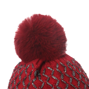 Red knit beanie with gold silk thread geometric diamond patterns and fluffy faux fur pompom