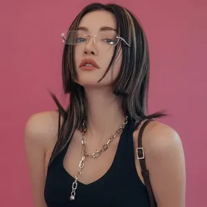 Chic rimless diamond-cut sunglasses with a yellow tint shown on a stylish fashion model