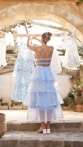 Detail of light blue backless tiered dress with ruffled layers and delicate tie straps