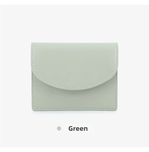 Detail shot of light green faux leather card holder with white contrast stitching