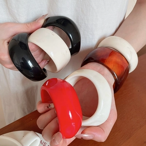 Detail shot of multi-colored resin acrylic bangles showing textures and glossy finish