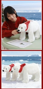 Polar bear plush toy with red scarf in a snowy arctic setting with a soft texture