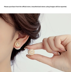 Macro detail of gold-plated zircon pavé earrings with creamy pearl back on model
