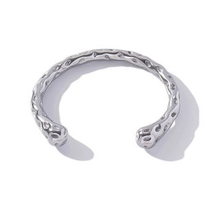 Detailed top view of silver open cuff bracelet with irregular hammered lava texture