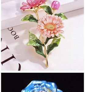 Detail of pink enamel daisy brooch with green leaves and golden floral texture