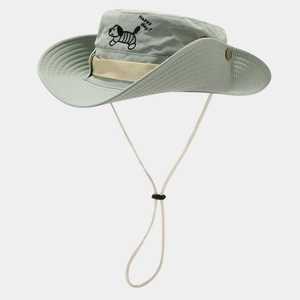 Detailed view of green bucket hat with dog embroidery and adjustable beige chin strap