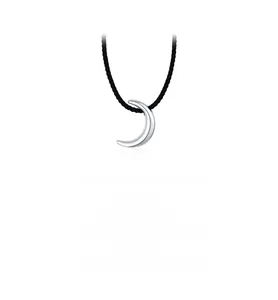 Detail view of a polished silver crescent moon pendant on a minimalist black woven cord