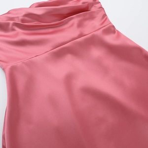 Detail of pink satin dress showing elegant pleats and smooth silky fabric texture
