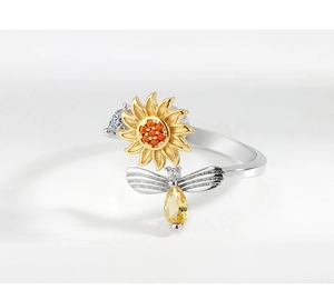 Macro detail of sunflower and bee ring with sparkling yellow and clear gemstones