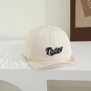 Detailed close-up of cream cotton baby baseball cap with black Today embroidery