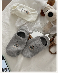 Close-up of cotton socks with cartoon dog embroidery and OFFWEGO lettering detail