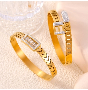Detailed view of gold plated chain link bracelets featuring crystal buckle and arrow motifs