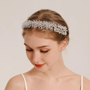 Macro detail of bridal crystal leaf headband featuring intricate beaded metal craftsmanship