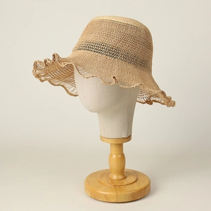 Handmade raffia sun hat for women featuring a wide wavy brim and breathable hollow weave