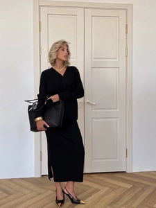 Elegant black two-piece knit set featuring a V-neck cardigan and a slit midi skirt