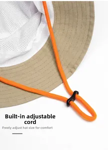 Close-up of adjustable orange cord lock and breathable mesh lining on khaki sun hat