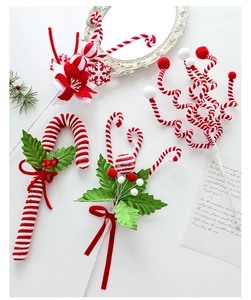Detail of red and white candy cane picks with holly leaves for Christmas tree decor
