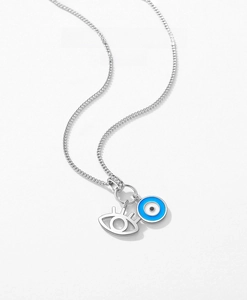 Macro shot of S925 sterling silver evil eye pendant with blue enamel and eyelash detail