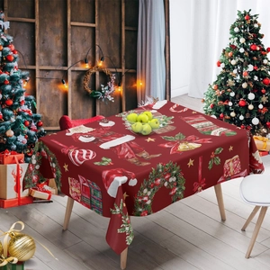 Festive red Christmas tablecloth with Santa Claus and gift prints on a wooden table