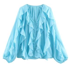 Detailed view of light blue ruffled chiffon shirt featuring layered V-neck and button closure