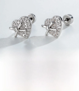 Detailed view of silver heart bow cartilage stud with micro-paved zircons and flat back