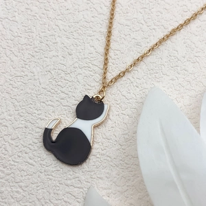 Cute black and white cat enamel pendant on a golden chain necklace jewelry accessory