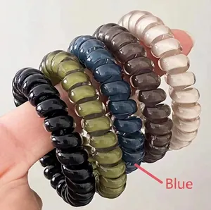 Close-up of high-elastic spiral phone cord hair ties in black, olive, navy, and brown