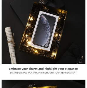 Detail of premium black gift box with LED string lights and shredded paper filler