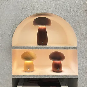 Minimalist mushroom-shaped wooden LED night lights with warm yellow glow in walnut and oak