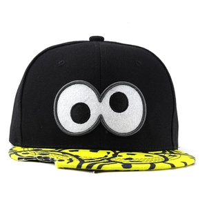 Detail of cartoon eyes embroidery and printed character graffiti on a snapback brim