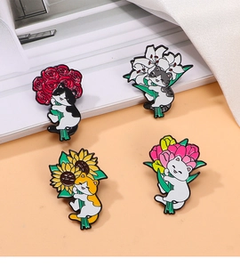 Detailed view of four colorful enamel cat pins holding different floral bouquets