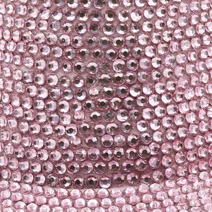 Close-up of sparkling pink and lilac rhinestones on a shimmering party cowboy hat
