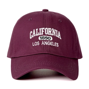 Detailed view of the white California 1850 embroidery on a burgundy cotton baseball cap