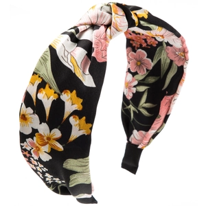 Detail of bohemian knotted headband with colorful floral print on black satin fabric