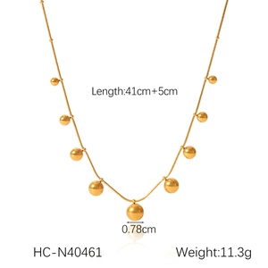 Detailed view of gold stainless steel snake chain with multiple round sphere pendants