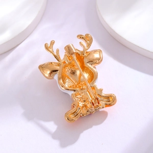 Golden Christmas reindeer brooch with colorful enamel finish and secure back pin closure