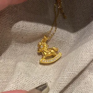 Dettaglio del ciondolo a cavallo a dondolo placcato oro 24K con intarsi in zirconi brillanti