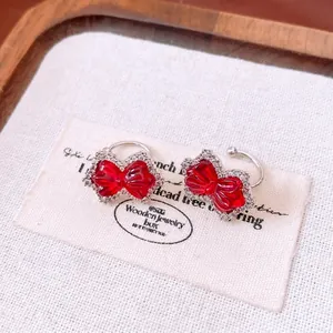 Red zircon bow clip-on earrings with shimmering rhinestones and silver-toned finish