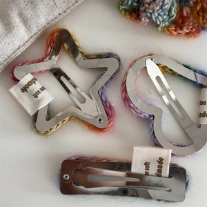 Close-up of handmade rainbow crochet hair clips set with Soft Handmade labels