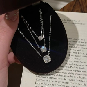 Three round zircon pendant necklaces in various sizes on O-chains in a velvet gift box