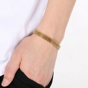 Close-up of gold titanium steel braided bracelet showing detailed woven texture on wrist