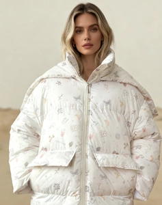Detail of hooded puffer jacket with colorful illustrations of butterflies and strawberries