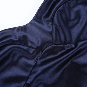 Detail of navy blue satin dress showing smooth fabric texture and fine sewing lines