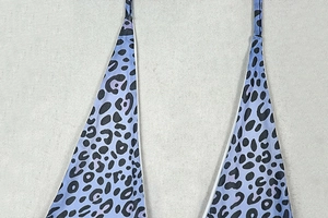 Close-up of blue leopard print fabric showing the halter neck detail and texture