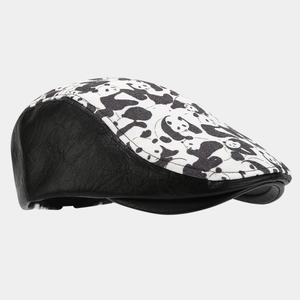 Detail of retro newsboy hat with panda pattern fabric and black lychee texture leather