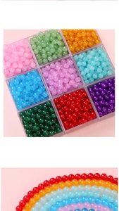 Macro detail of 4-10mm colorful round jelly glass beads in a 9-slot clear storage box