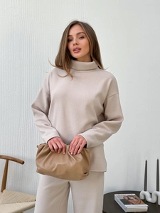 Women beige high neck long sleeve knitted top and pants set with soft clutch bag