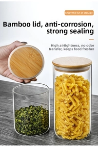 Detailed view of glass storage jars with bamboo lids for pasta and loose tea leaves